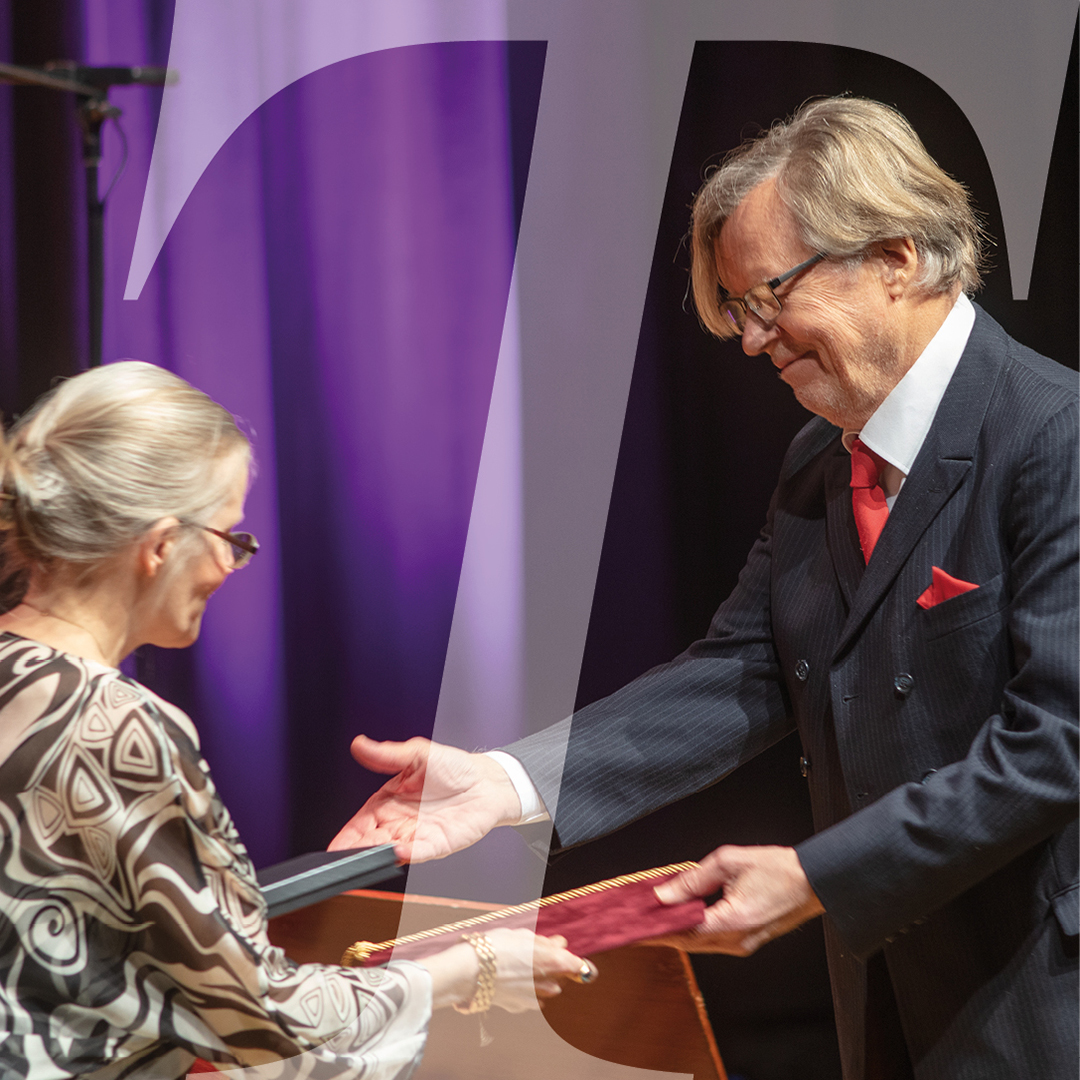 Prisnämndens ordförande Pauline von Bonsdorff delar ut emot SLS största pris Karl Emil Tollanders pris till författaren Fredrik Lång på SLS årshögtid 2021.